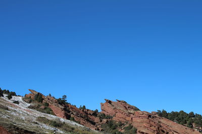 Low angle view of mountain against blue sky