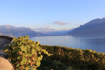 Scenic view of sea and mountains against sky