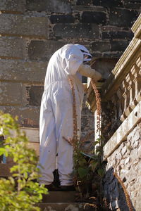 Rear view of man standing against wall