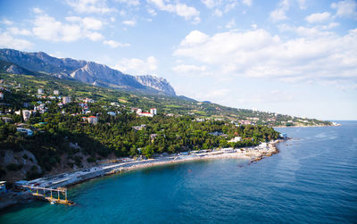 Scenic view of sea and buildings against sky