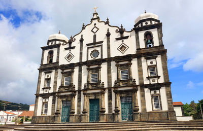 Low angle view of church against cloudy sky