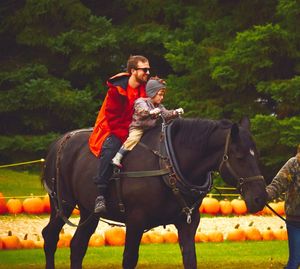 Father and son riding horse 