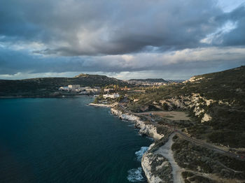 Aerial view of sea and mountains against sky