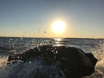 Scenic view of sea against clear sky at sunset