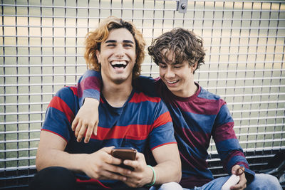 Portrait of a smiling young man sitting outdoors