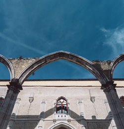 Low angle view of arch bridge against sky