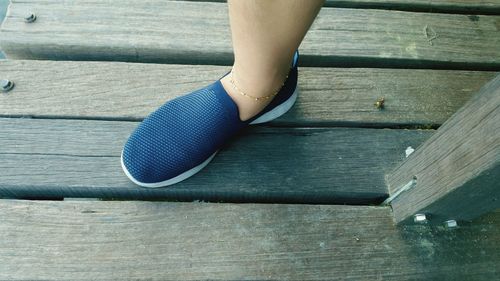 Low section of woman on wooden floor