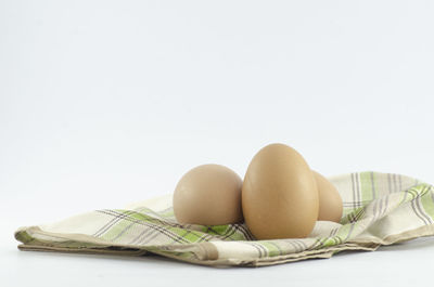 Close-up of eggs against white background