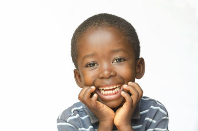 Portrait of smiling boy against white background