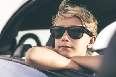 Portrait of man wearing sunglasses in car