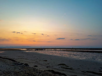 Scenic view of beach against sky during sunset in grado, italy