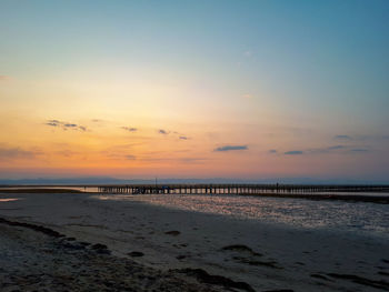 Scenic view of beach against sky during sunset