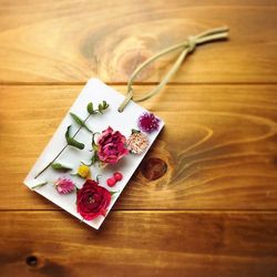 Directly above shot of flowers over paper on table