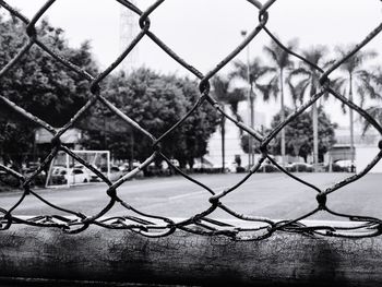 Close-up of chainlink fence against sky