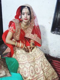Portrait of a beautiful young woman sitting in temple