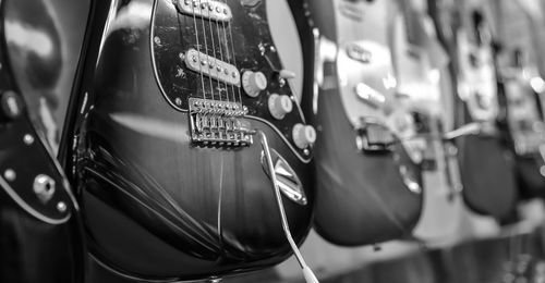 Close-up of guitars for sale at store