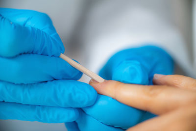 Close-up of woman hand holding finger