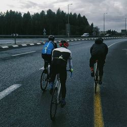 People riding bicycle on road
