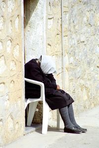 Woman standing against wall