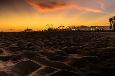 Scenic view of silhouette beach against sky during sunset
