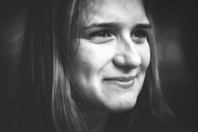 Close-up of smiling woman looking away