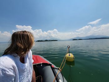 Rear view of woman against sea against sky