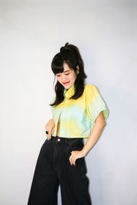 Young woman standing against white background