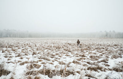 Scenic view of snow field against sky during winter