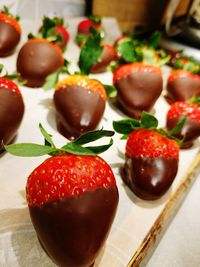 Close-up of strawberries with chocolate sauce on table