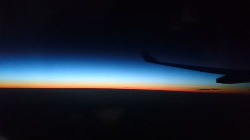 Cropped image of airplane flying over landscape