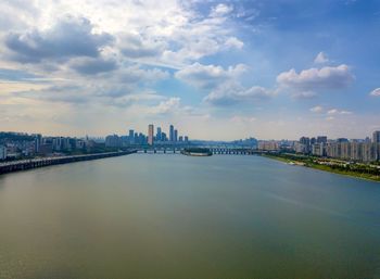 Bridge over river with buildings in background