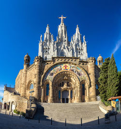 Low angle view of historical building against blue sky