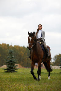 Horses on field against sky