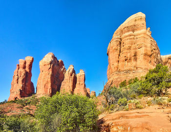 Rock formations on mountain against clear blue sky