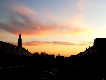 Low angle view of buildings against sky at sunset