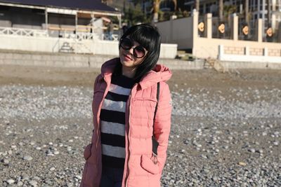 Portrait of woman standing at beach