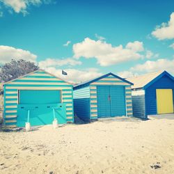 Built structure on beach against blue sky