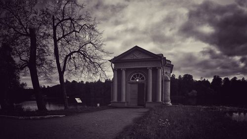 Entrance of building against cloudy sky