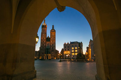 Market medieval square of krakow at sunrise view from the arch of old palace.