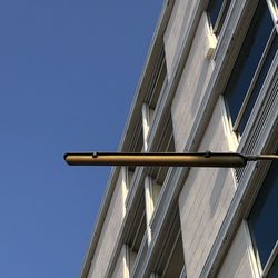 Low angle view of modern building against clear blue sky