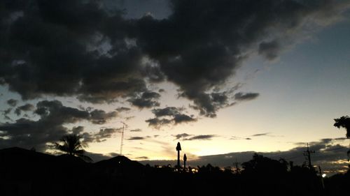 Low angle view of silhouette trees against sky