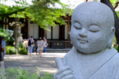 Close-up of statue with people in background