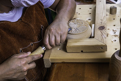 Wood craftswoman carving wooden box