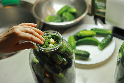 Cropped hand of woman preparing food on table