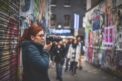 Side view of woman photographing