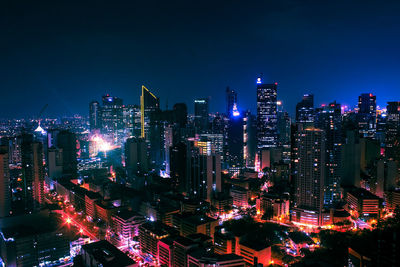 High angle view of city lit up at night