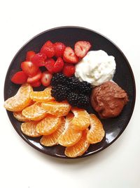 Close-up of food in plate against white background