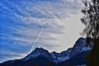 Low angle view of snowcapped mountains against sky