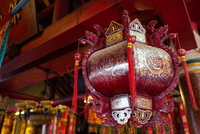 Low angle view of lanterns hanging in temple outside building