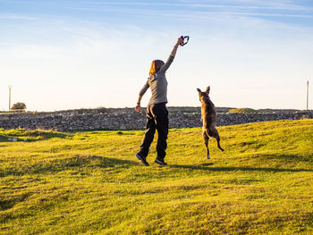 Full length of man standing on field against sky